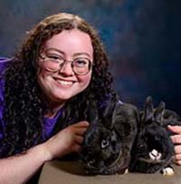 Mikayla Thompson with two black bunnies